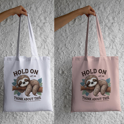 Sleepy Sloth PNG design with quote “Hold On, Let Me Think About This” on tote bags by Style Junction Custom Digital Designs.